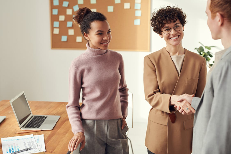 Woman and man shaking hands